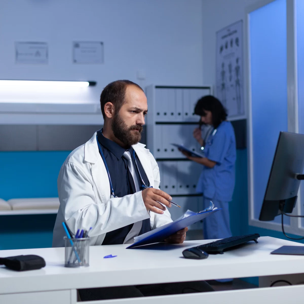 doctor-using-computer-checkup-files-healthcare-work